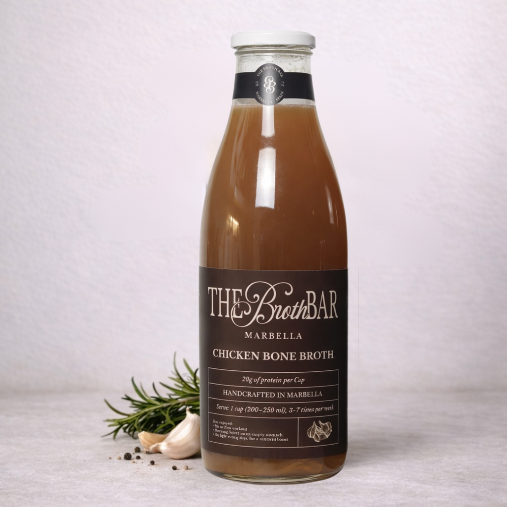 Bottle of The Broth Bar chicken bone broth on a light background